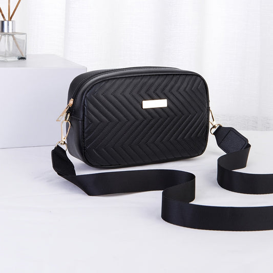 Elegante bolso ligero para mujer, con diseño de rayas y acolchado con herrajes dorados.