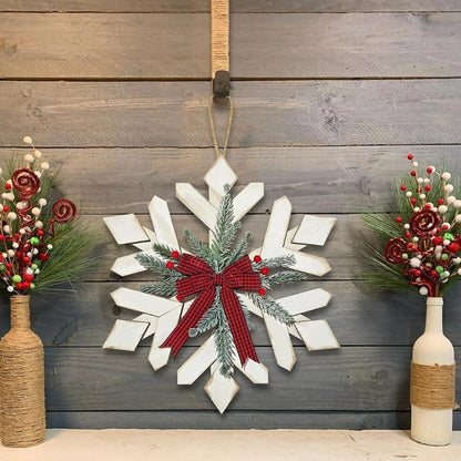 Decoración de pared rústica con copos de nieve, ramas de abeto y lazo de cuadros