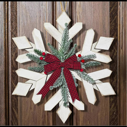 Decoración de pared rústica con copos de nieve, ramas de abeto y lazo de cuadros