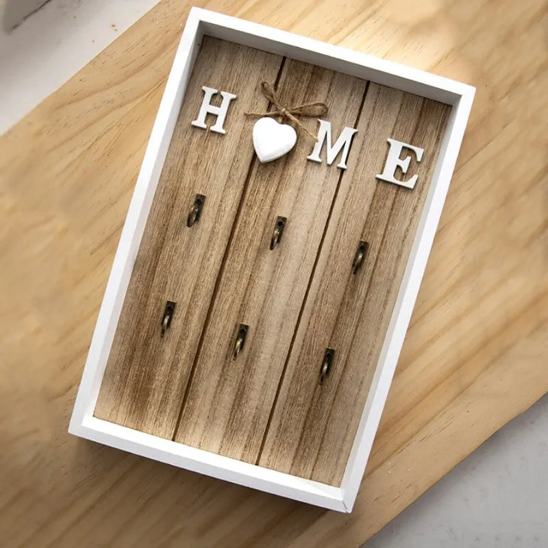 Tablero para llaves de madera con 6 ganchos y la inscripción «Home»