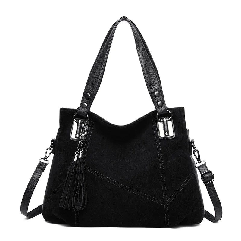 Damenhandtasche mit Schulterriemen und dekorativen Quasten