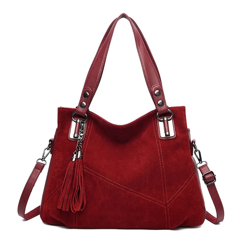 Damenhandtasche mit Schulterriemen und dekorativen Quasten