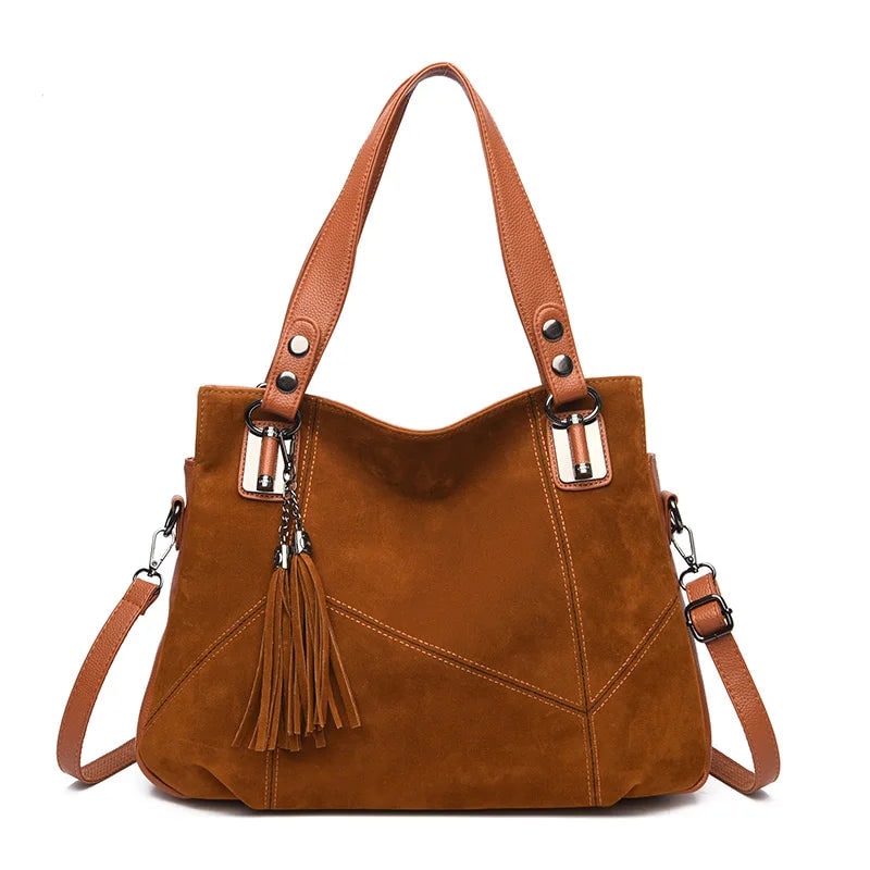 Damenhandtasche mit Schulterriemen und dekorativen Quasten