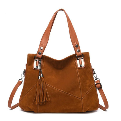 Damenhandtasche mit Schulterriemen und dekorativen Quasten